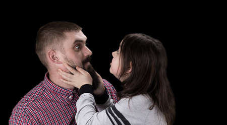 happy father and daughter hugging on black background.