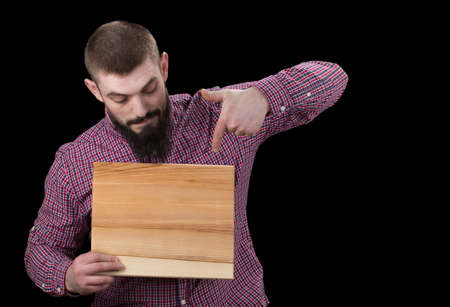 concept inscription on a wooden board in hands.Smiling man holding advertising sheet, copy space.