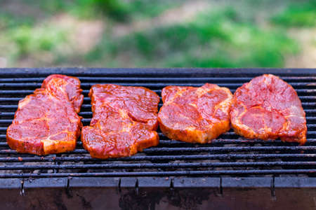 Beef steaks on the grill with flames.の写真素材