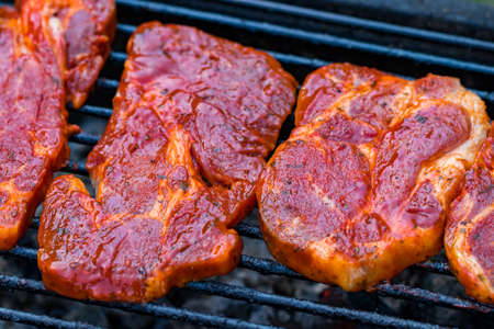 Beef steaks on the grill with flames.の写真素材