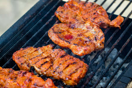 Beef steaks on the grill with flames.の写真素材