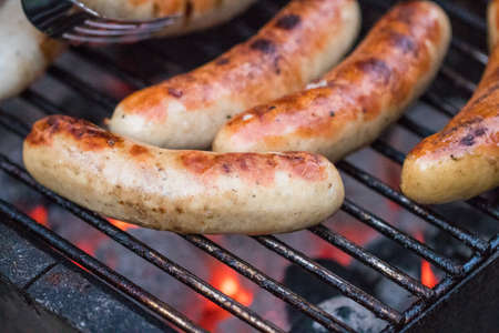 Grilling sausages on barbecue grill. Selective focus.の写真素材