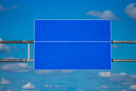 Big blank highway road sign with gradient blue sky.の写真素材