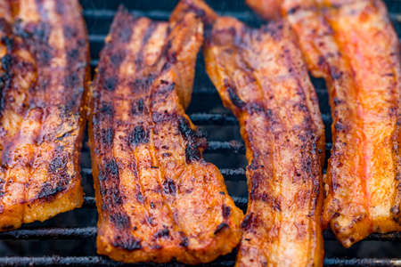 Assorted mixed grill from chicken meat, and pork, sausages  roasting on barbecue grid cooked for summer family dinner.の写真素材