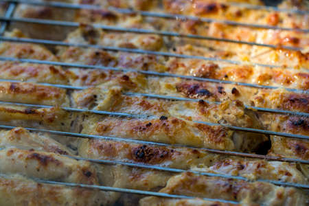 Grilled chicken thigh on the flaming grill.の写真素材