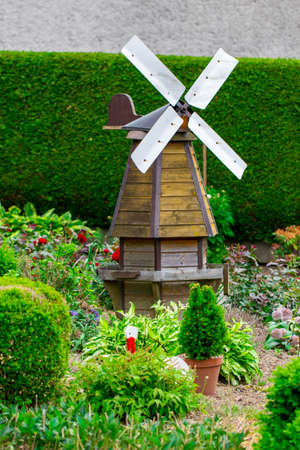 small windmill among the trees in the garden.の写真素材