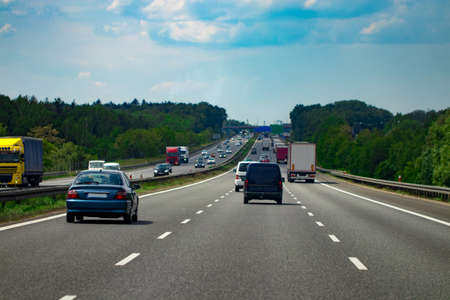 road with cars and blue sky with clouds.