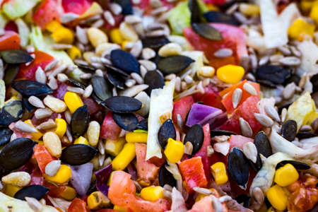 Healthy salad with cabbage, tomatoes, corn and pumpkin seedsの写真素材
