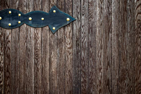 wooden gate with wrought iron elements close up.の写真素材