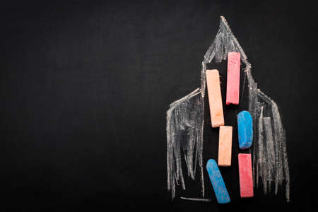 Back to school background with rocket made from pencils with copy space . View from above.の写真素材