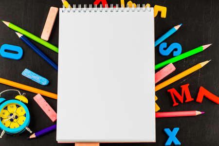 School supplies on blackboard background with copy space.