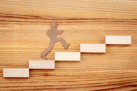 Graph or wooden steps on wooden background. Business success strategy goals concept.の写真素材
