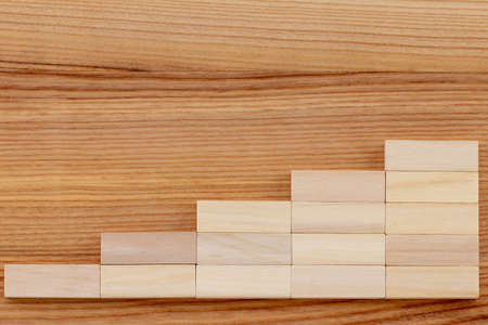 Graph or wooden steps on wooden background. Business success strategy goals concept.