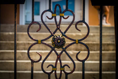 The wrought-iron gates, ornamental forging, forged elements close-up.の写真素材