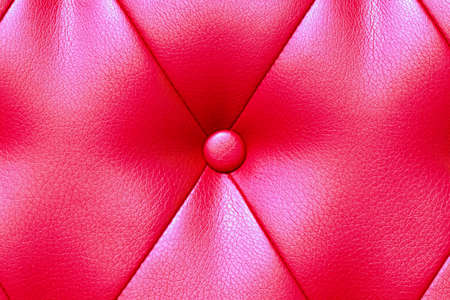 Elegant saturated glossy red leather texture of sofa chair.の写真素材