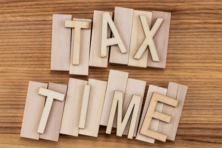 tax time -  text in vintage letters on wooden blocks.の写真素材
