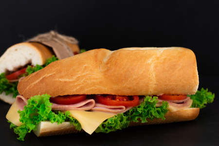 Big sandwich with meat and cheese on dark background.の写真素材