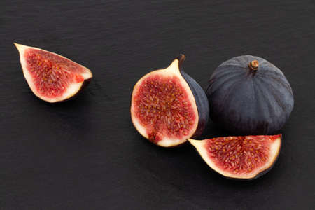 Fresh figs on dark background, top view.の写真素材