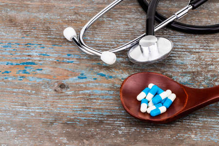 Medical, stethoscope pills on wooden background  with copy space.の写真素材