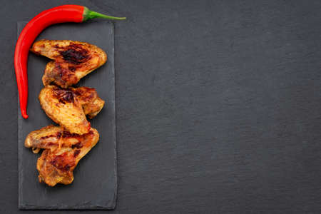 Baked chicken wings on dark  with copy space.Top view.の写真素材