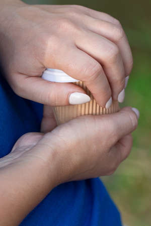 A paper cup of coffee in the hand.の写真素材