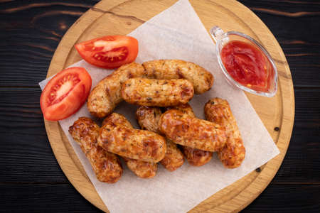 Tasty grilled sausage on the wooden background.の写真素材