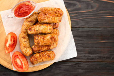 Tasty grilled sausage on the wooden