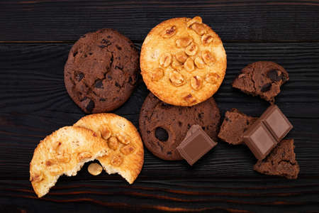 Chocolate cookies on wooden table. Homemade food on wooden background