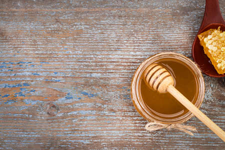 Honey background. Fresh honey in the pot with honeycombs.の写真素材