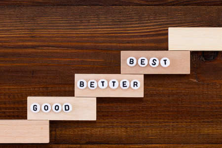 Good - Better - Best. On the wooden background.の写真素材