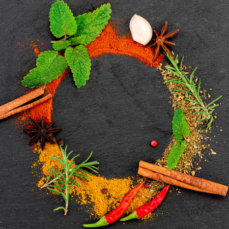 Colourful various herbs and spices on dark background. Top view with copy space.の写真素材