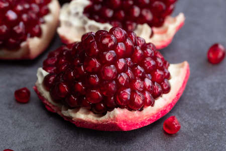 Ripe pomegranate fruits on a dark background.の写真素材