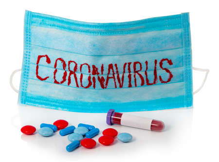 Protective mask with CORONAVIRUS and test tube with blood on whiteの写真素材