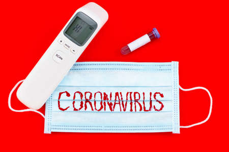 Protective mask with CORONAVIRUS and test tube with bloodの写真素材