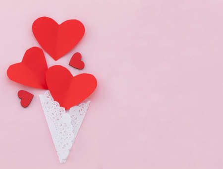 Valentines Day background. Red hearts on pastel pink background. Valentines day concept. Flat lay, top view, copy space.の写真素材