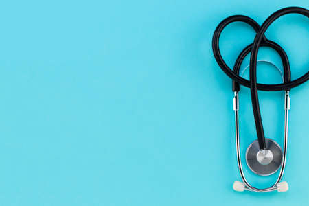stethoscope on blue background. Top view with copy space.