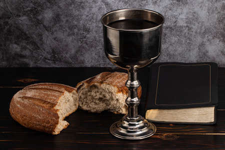 Holy communion chalice with wine and bread.の写真素材