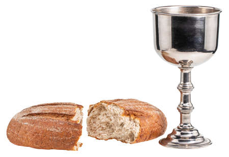 Holy communion chalice with wine and bread isolated on whiteの写真素材