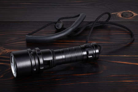  flashlight on wooden background with copy space.