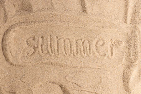 Summer is written in the sand. Sandy beach for background. Summer background.