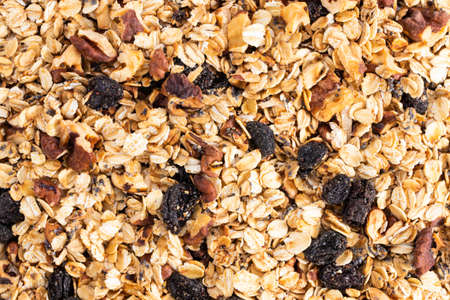 Organic homemade Granola Cereal with oats, nuts and raisins. Texture oatmeal granola or muesli as...