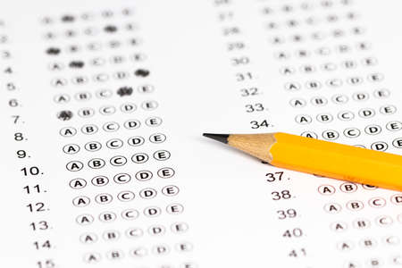 Answer sheet form with pencil on table, close up.の写真素材