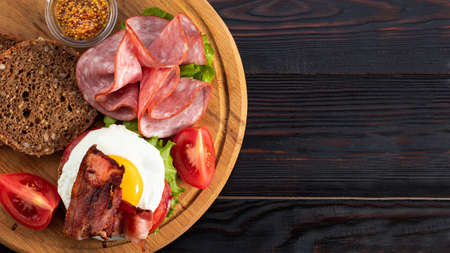 ham and egg bacon sandwich on dark wooden background with copy space. Top view. Flat lay.の写真素材