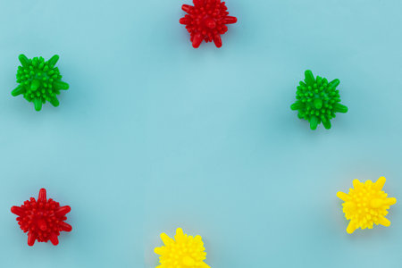 multicolored balloons coronavirus symbol on blue background with copy space.
