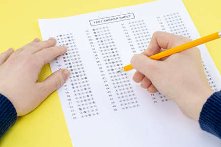 Exam. Filling in the test with a pencil.