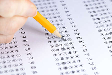 Exam. Filling in the test with a pencil.の写真素材