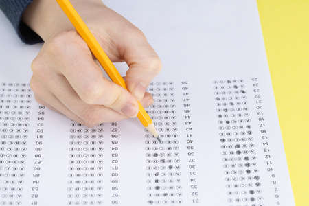 Exam. Filling in the test with a pencil.の写真素材