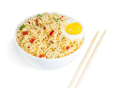 Instant noodles with vegetables and herbs in bowl isolated on white.の写真素材