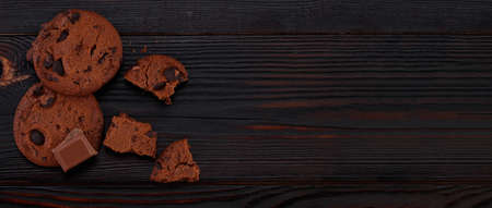 Chocolate chip cookies on dark old wooden table with copy space.の写真素材
