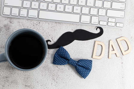 Happy fathers day! Cup of coffee and keyboard on table. Top view.の写真素材